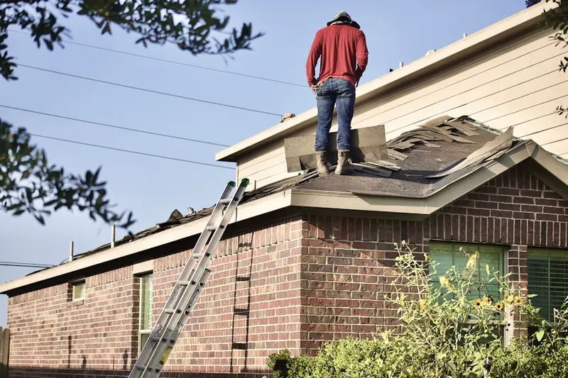 Professional roofer working on a residential roof in Turkey Point Corner